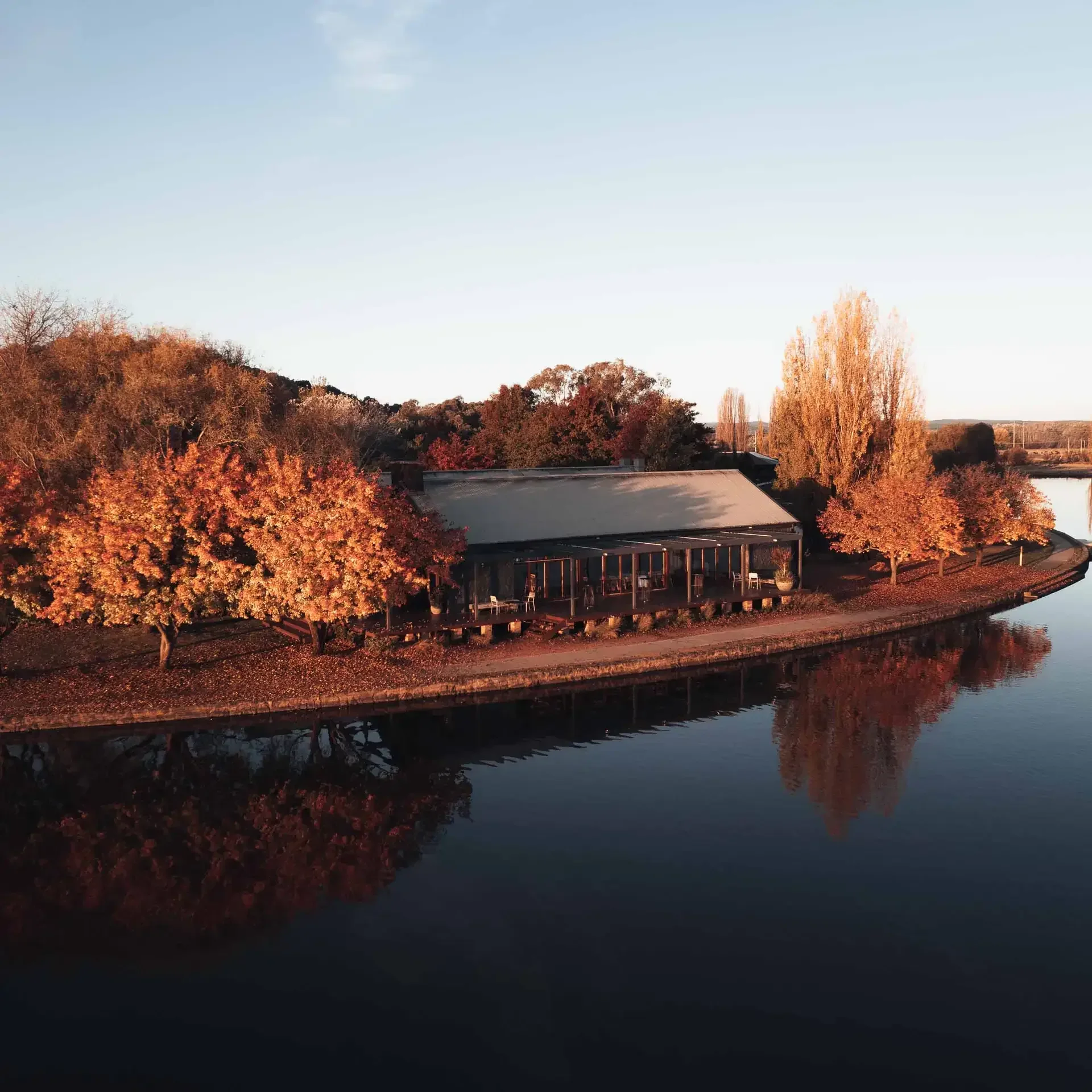 The Boat House surrounded by autumn trees on Lake Burley Griffin